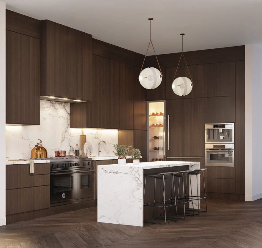 The kitchen’s dark cabinets juxtapose the light countertops and island PHOTO COURTESY OF BRAND