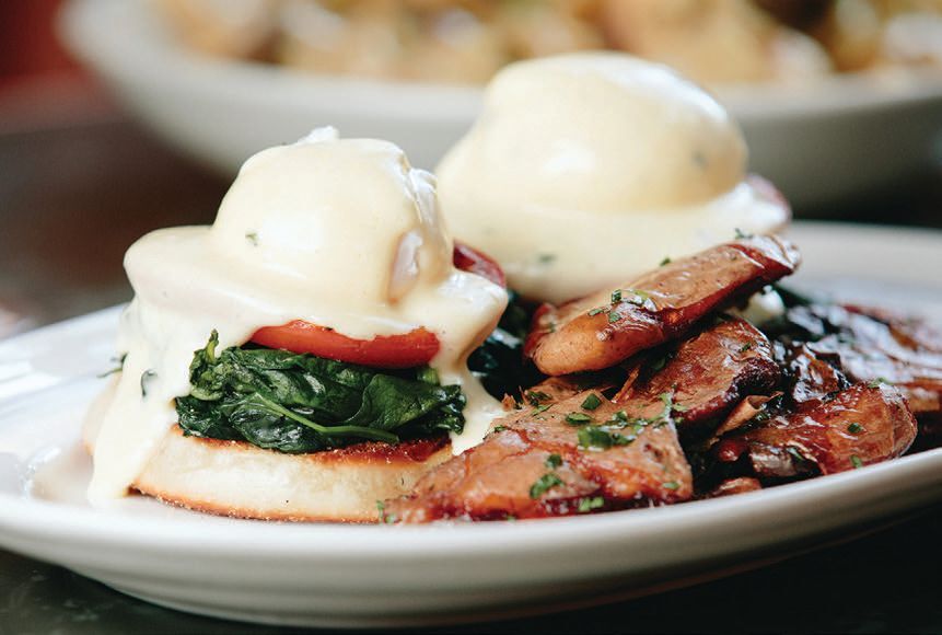 Rochambeau’s eggs benedict is a treat featuring two poached eggs, brunch potatoes, gruyére, French ham and creamy hollandaise PHOTO COURTESY OF BRAND
