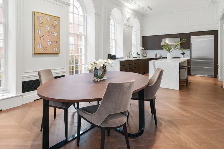 A perfect marriage of the old and new can be found in the kitchen
and dining space where a modern marble island and historic, arched windows
meet PHOTO BY JACK VATCHER PHOTOGRAPHY