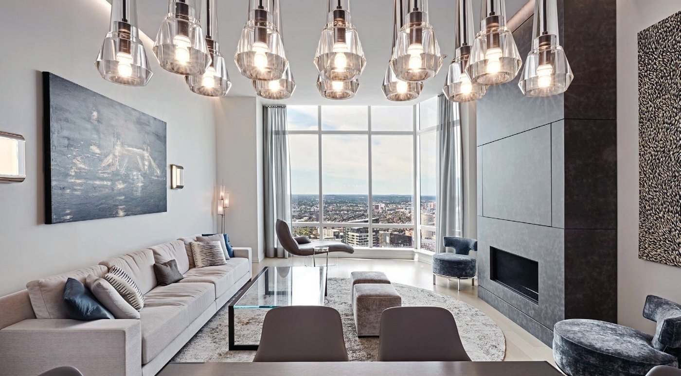 The living room in this Millennium Tower property offers stunning views of Boston Common, the Charles River and the Back Bay neighborhood PHOTO COURTESY OF DOUGLAS ELLIMAN REAL ESTATE