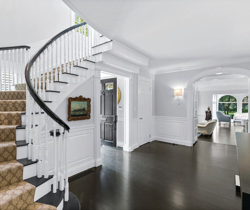 Dark hardwood floors contrast the white walls for a clean, chic look. PHOTO BY ATLANTIC VISUALS LLC